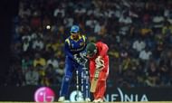 Zimbabwe cricketer Regis Chakabva (R) gets dismissed by Sri Lankan spinner Muttiah Muralitharan (unseen) as wicketkeeper Kumar Sangakkara (L) watches
